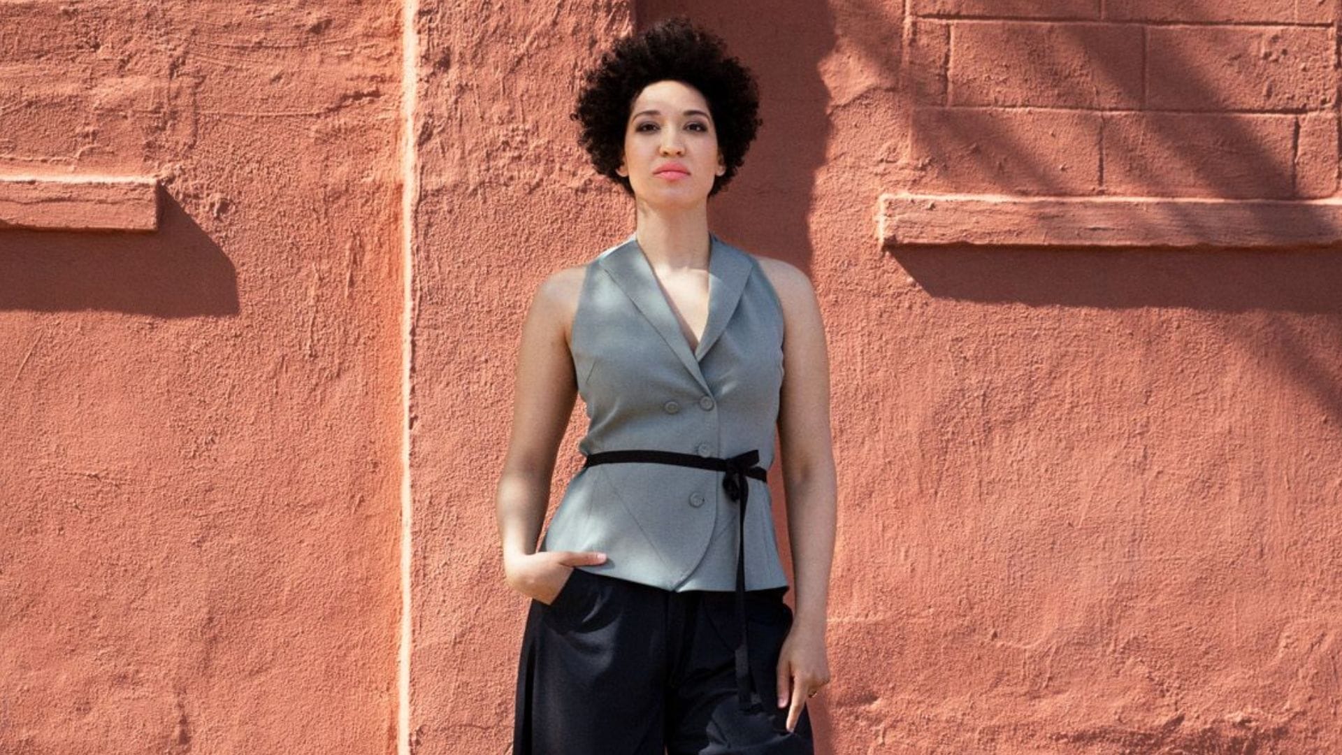 Singer Julia Bullock standing in front of a terracotta wall