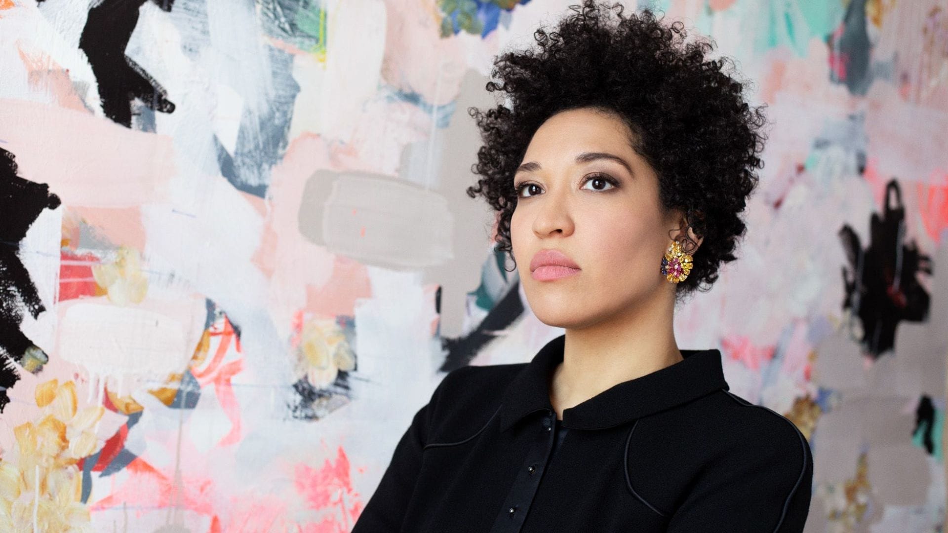 Singer Julia Bullock sitting in front of an abstract painting