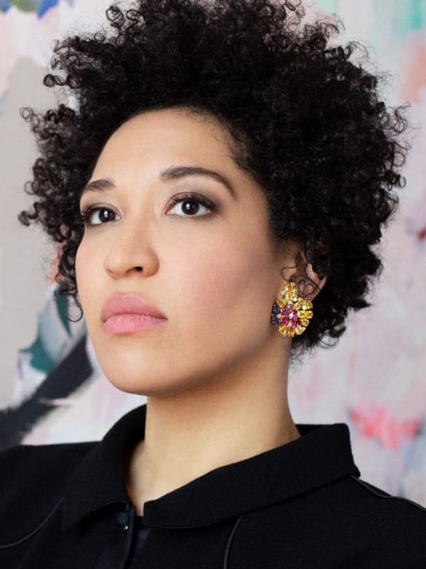 Singer Julia Bullock sitting in front of an abstract painting