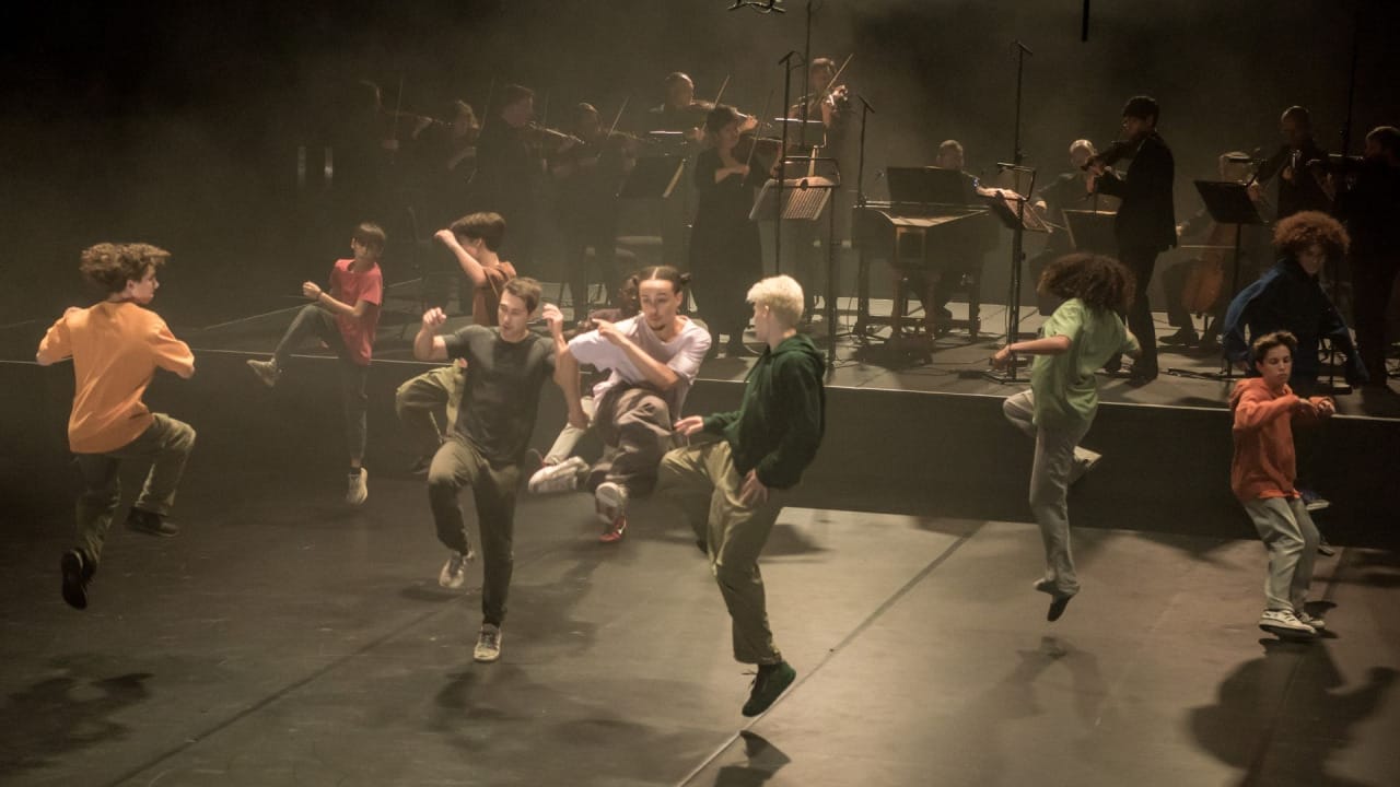 A group of dancers who are all mid-jump