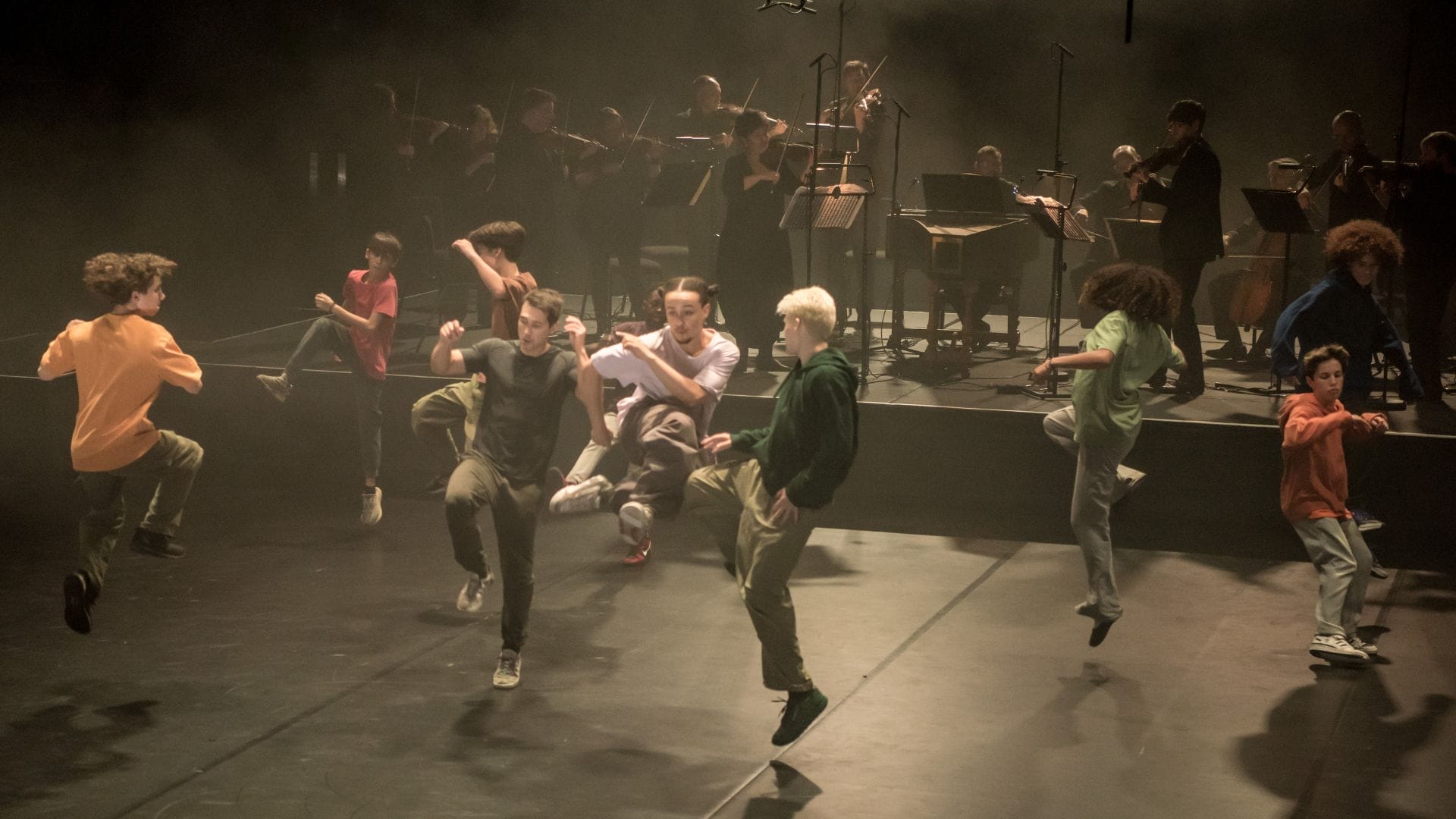 A group of dancers who are all mid-jump