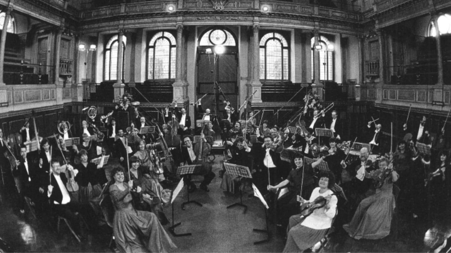 A historic photo of the OAE in the Sheldonian Theatre in Oxford